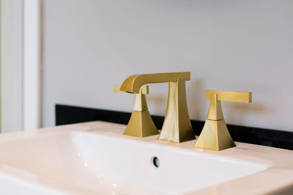 Satin brass Rubinet faucet with Duravit sink, designed by Qarnis Development for a luxury Toronto bathroom.